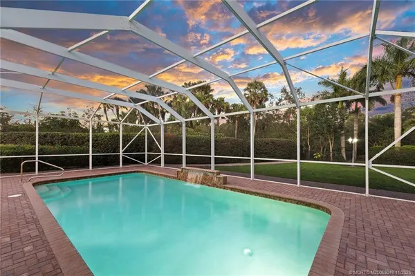 a view of a room with wooden floor and windows