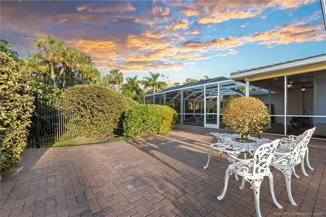 a view of a chair and table in the backyard