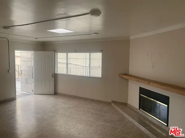 a view of empty room with a fireplace