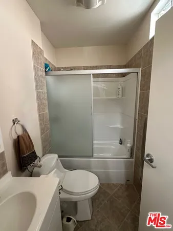 a bathroom with a shower and toilet