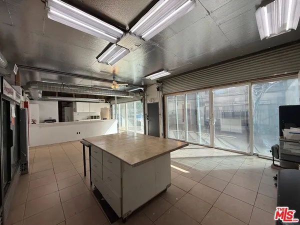 a kitchen with refrigerator and chairs