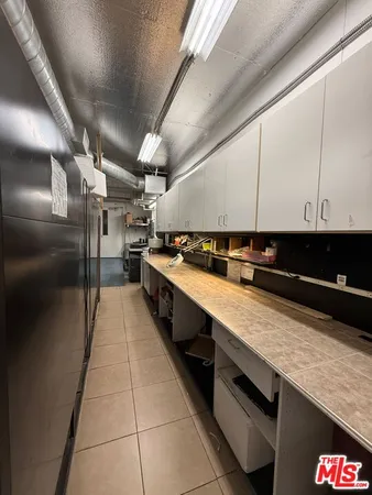 a workspace with wooden floor and a window