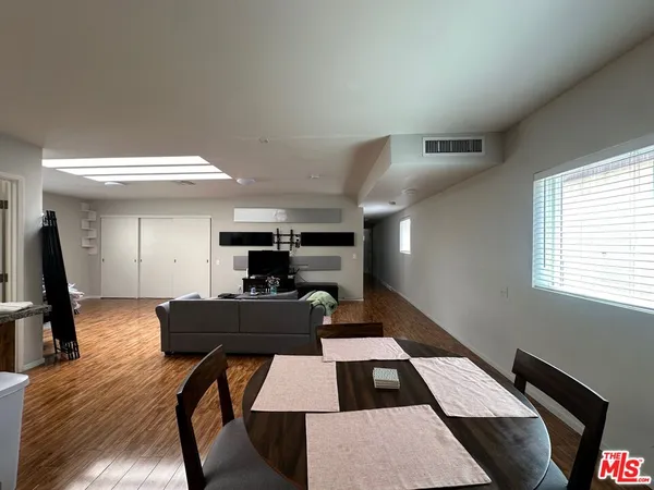 a dining room with furniture and wooden floor
