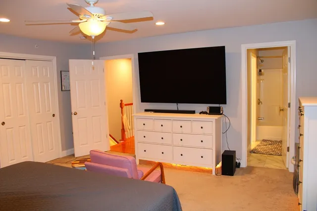 a bedroom with a bed and flat screen tv