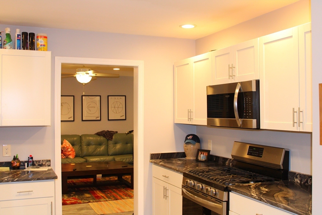 10 North Court Street, Unit 3 Fall River, MA 02720 - Photo 3 of 26 a kitchen with stainless steel appliances granite countertop a stove and a sink