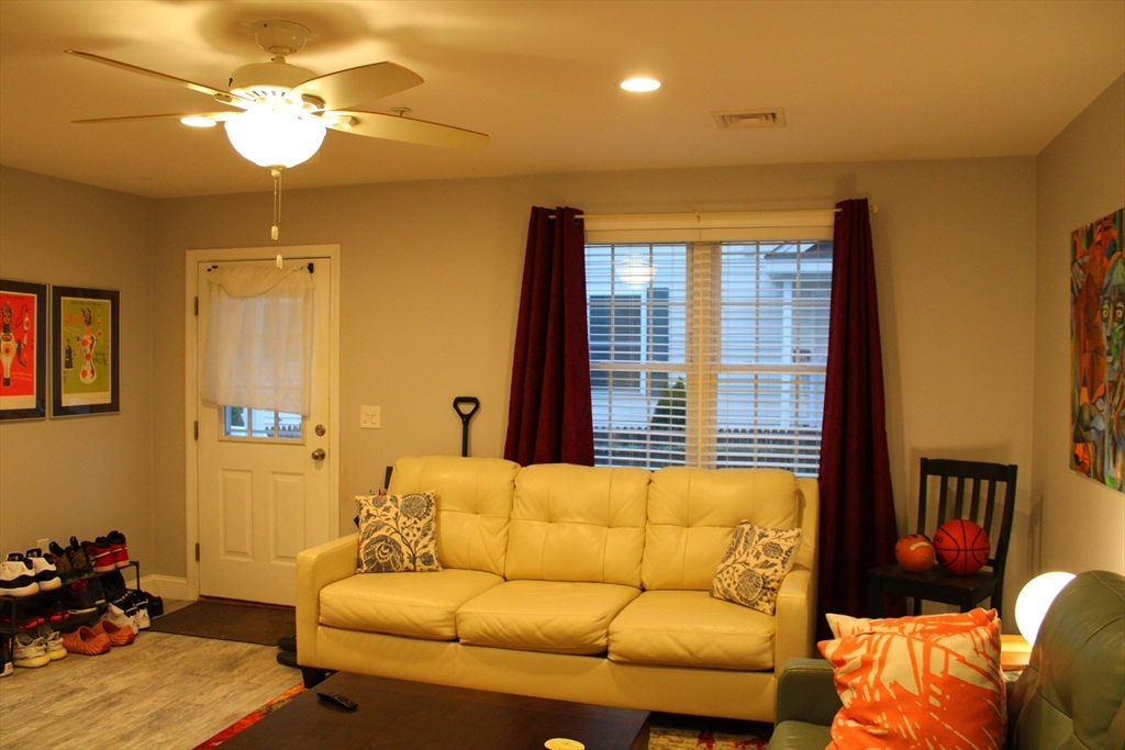 10 North Court Street, Unit 3 Fall River, MA 02720 - Photo 6 of 26 a blue couch sitting in a living room next to a window