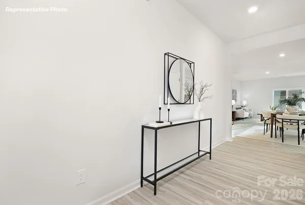 a view of a room with wooden floor and white walls