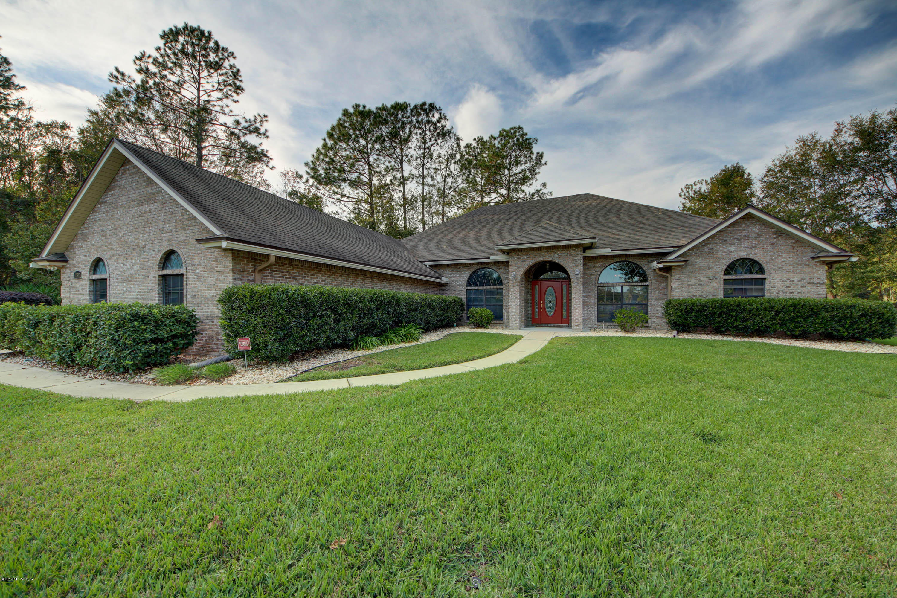1302 Sinclair Lane Jacksonville, FL 32221 - Photo 1 of 32 a front view of a house with a yard and garage