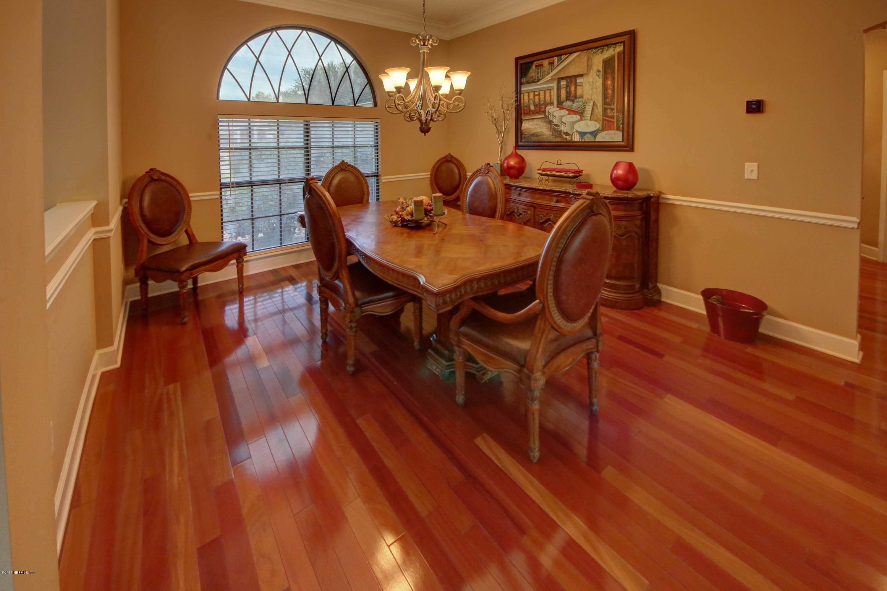 1302 Sinclair Lane Jacksonville, FL 32221 - Photo 3 of 32 a view of a dining room with furniture a chandelier and wooden floor