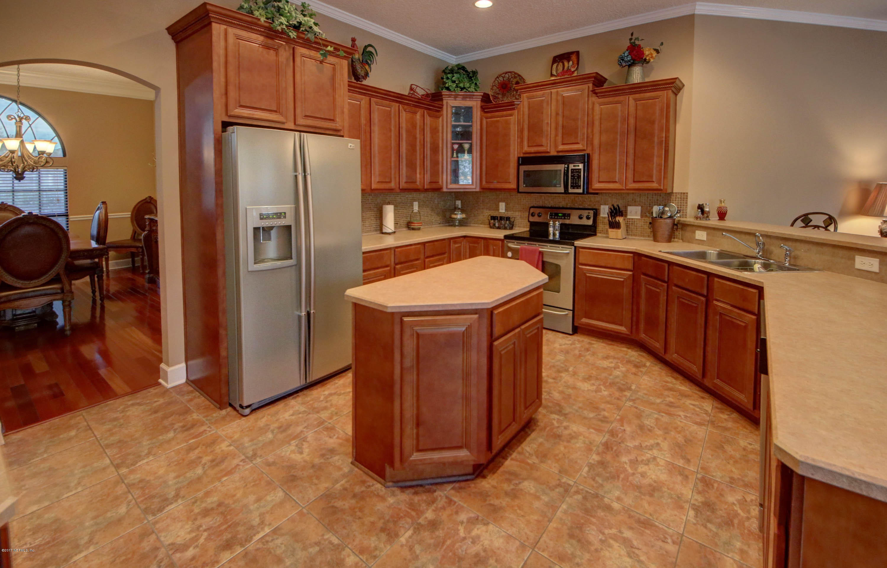 1302 Sinclair Lane Jacksonville, FL 32221 - Photo 8 of 32 a kitchen with stainless steel appliances granite countertop a refrigerator a sink a stove and a microwave