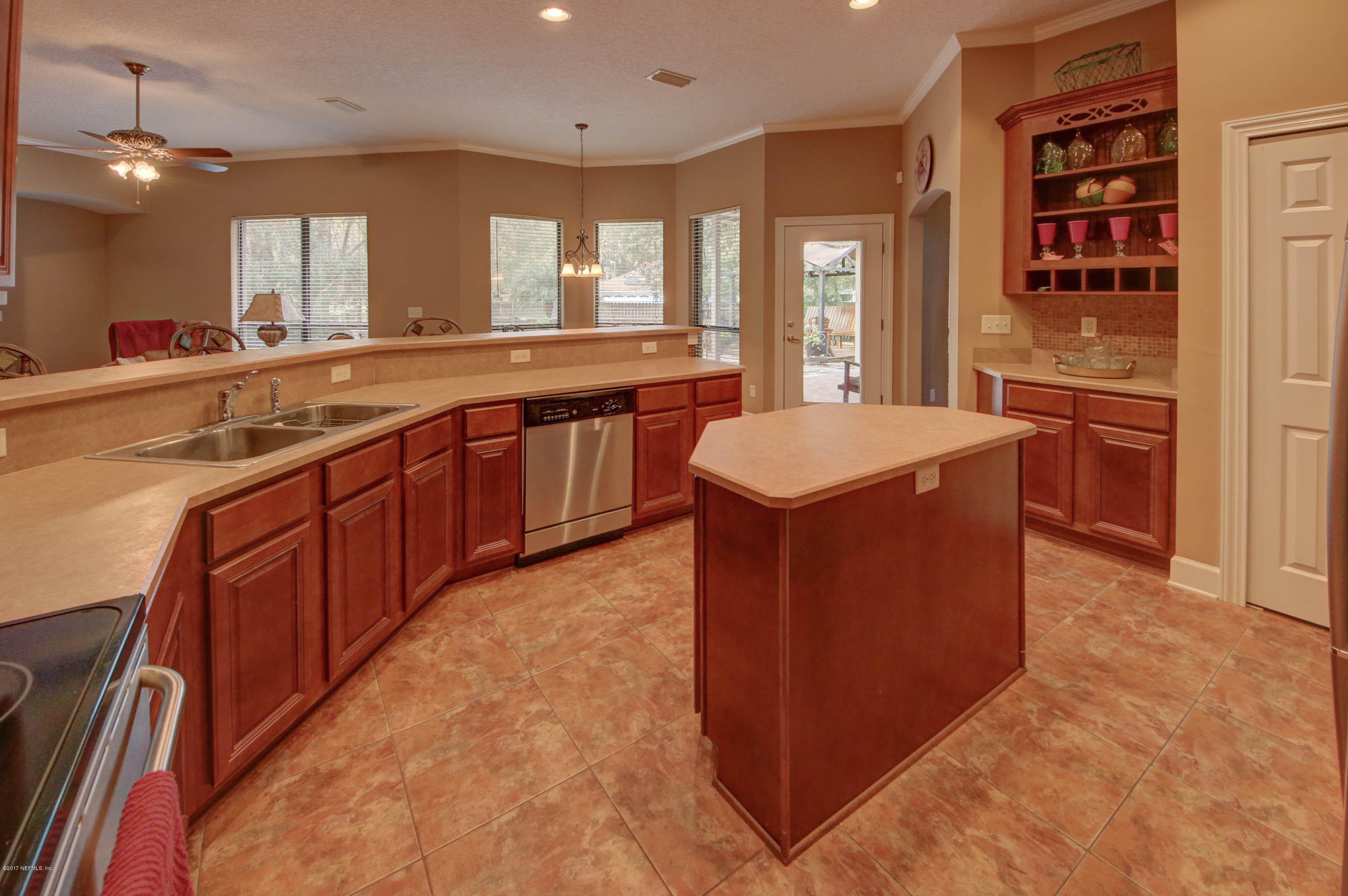 1302 Sinclair Lane Jacksonville, FL 32221 - Photo 9 of 32 a kitchen with stainless steel appliances granite countertop a sink and a stove