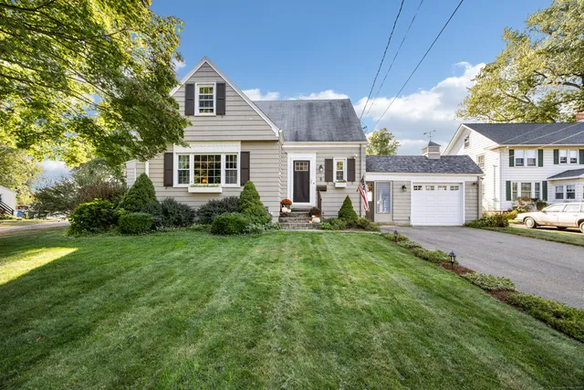 a front view of a house with a yard and a garage