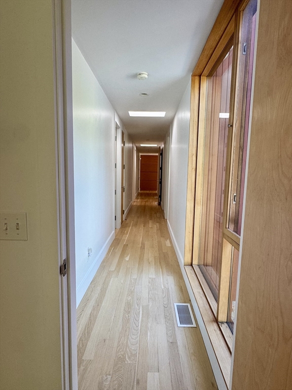 4 Solstice Way Sharon, MA 02067 - Photo 15 of 22 a view of a hallway with wooden floor and furniture