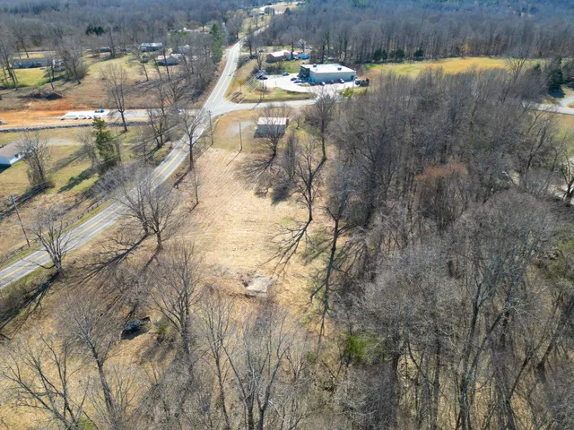 a aerial view of a house with a yard and wooden fence
