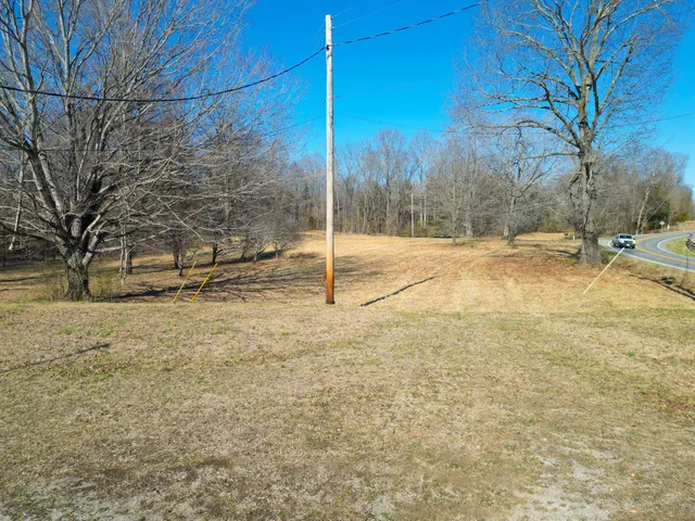 a view of a yard with wooden fence