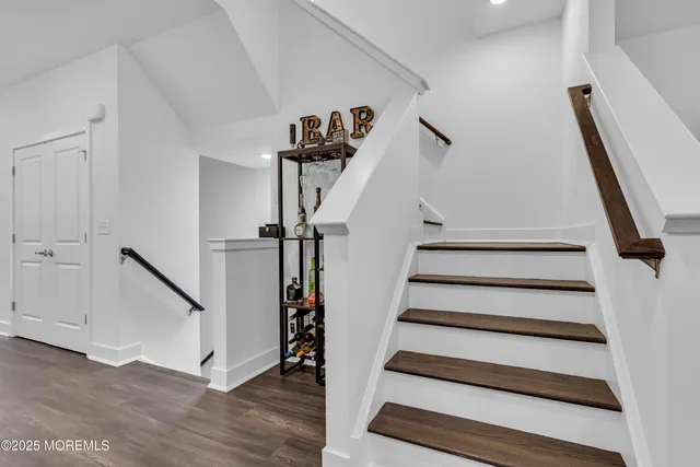a living room with furniture a flat screen tv and a floor to ceiling window