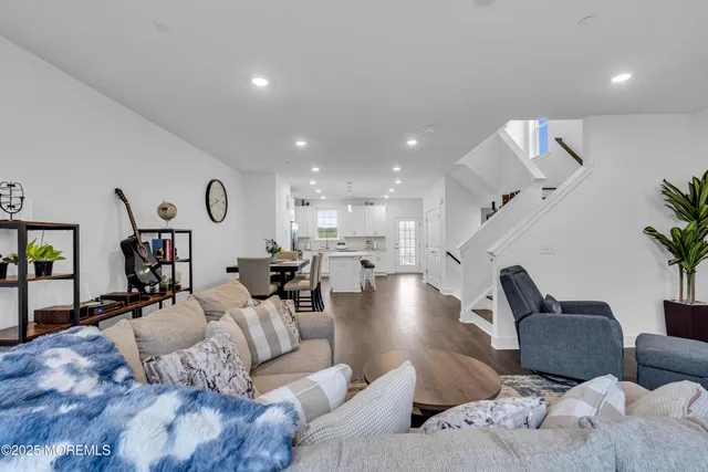 a kitchen with stainless steel appliances granite countertop a refrigerator stove top oven and sink