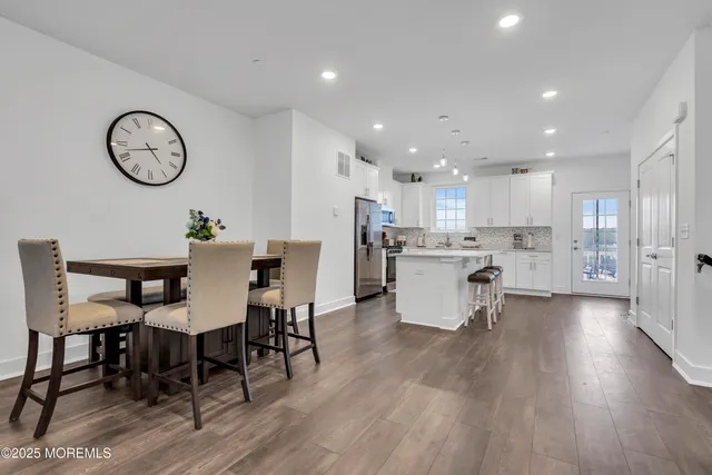 a kitchen with granite countertop white cabinets and stainless steel appliances