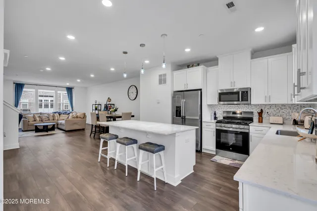 a bathroom with a double vanity sink a toilet and a mirror