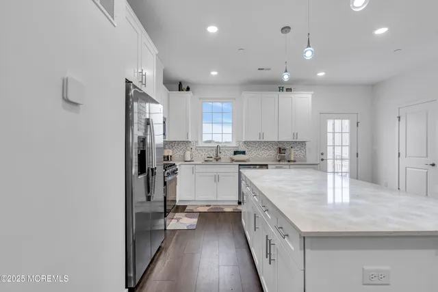 a bedroom with a bed and painting on the wall