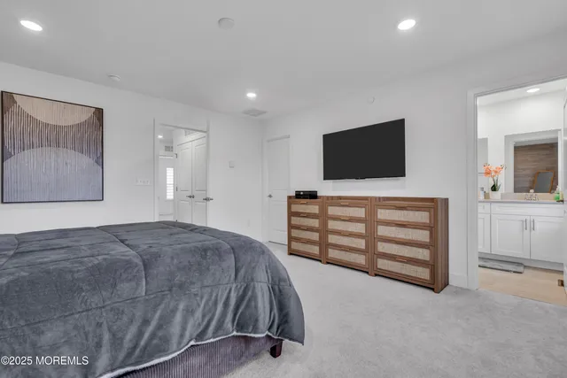 a bathroom with a granite countertop sink mirror vanity and toilet