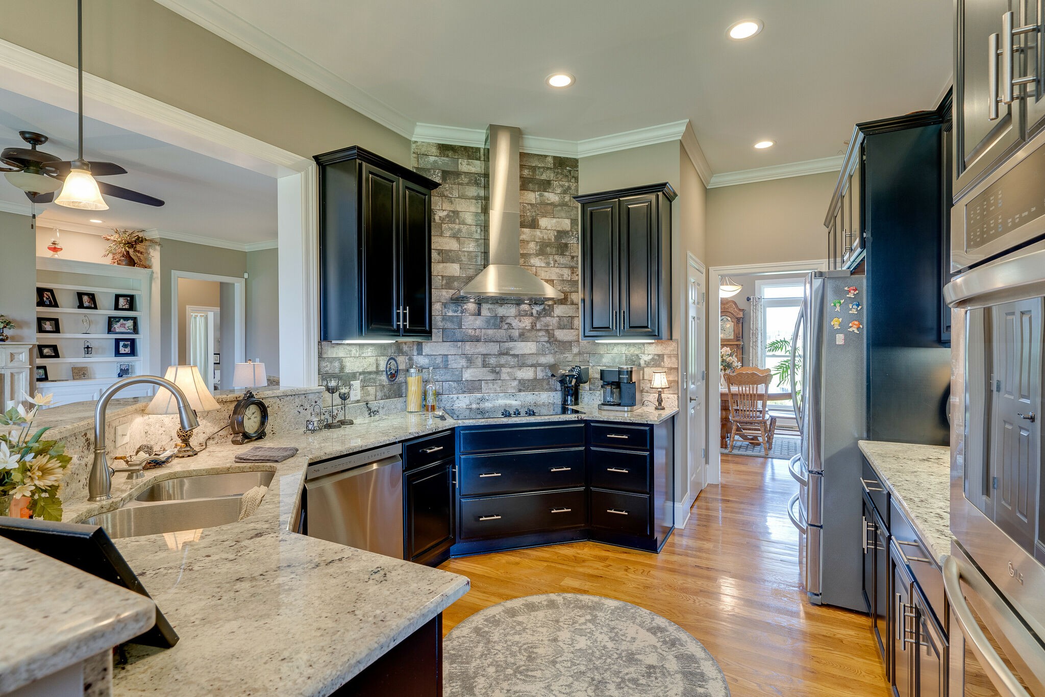 8882 New Chapel Road Springfield, TN 37172 - Photo 15 of 60 a large kitchen with granite countertop a sink and cabinets