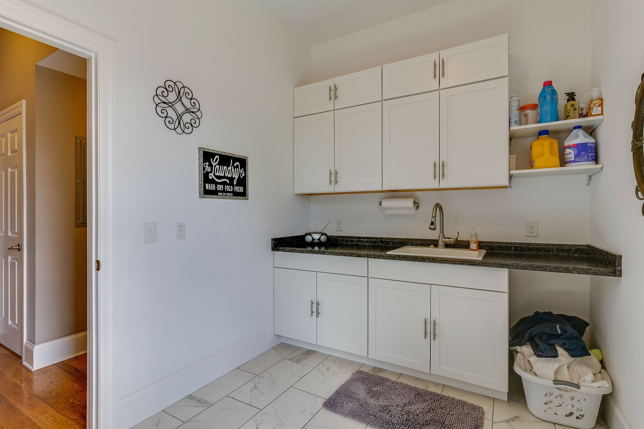8882 New Chapel Road Springfield, TN 37172 - Photo 30 of 60 a kitchen with stainless steel appliances granite countertop a sink and a stove with white cabinets