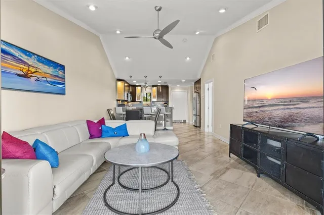 a living room with furniture and kitchen view