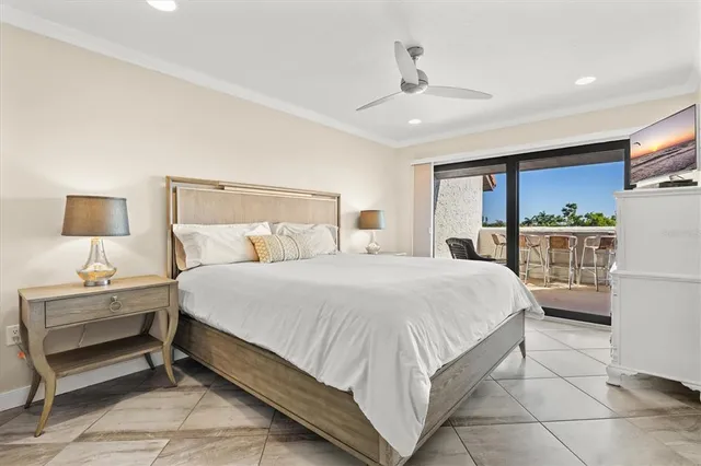 a bedroom with a large bed and a large window