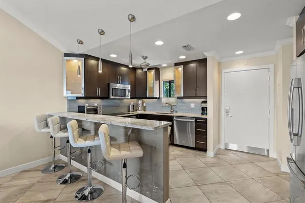 a large kitchen with a table and chairs