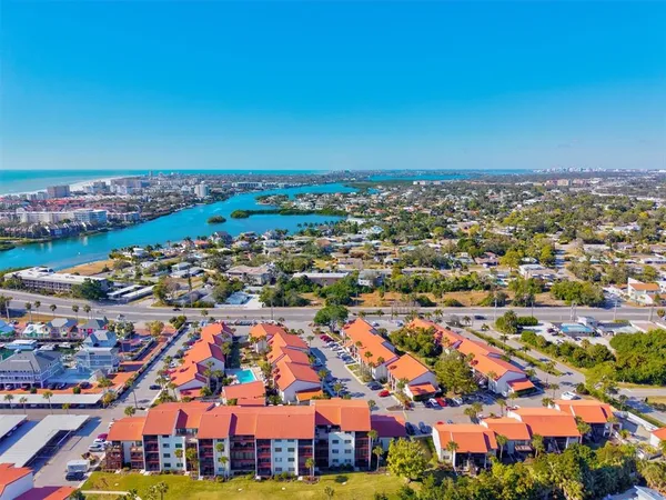 an aerial view of multiple houses with yard