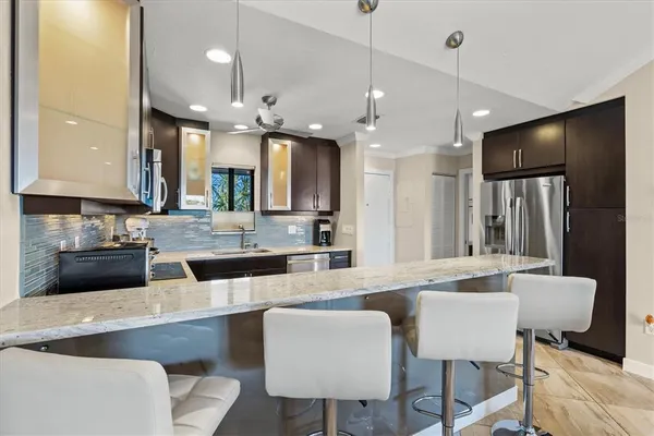 a kitchen with stainless steel appliances a sink stove and cabinets