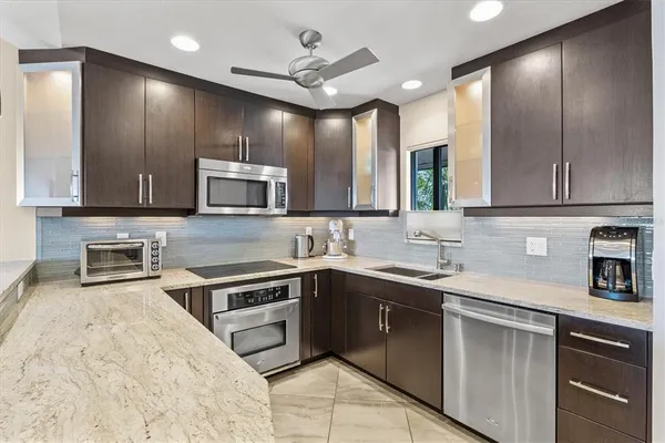 a kitchen with a sink stove and microwave