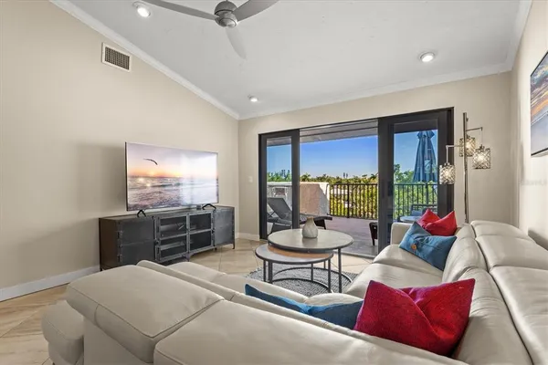 a living room with furniture and a floor to ceiling window