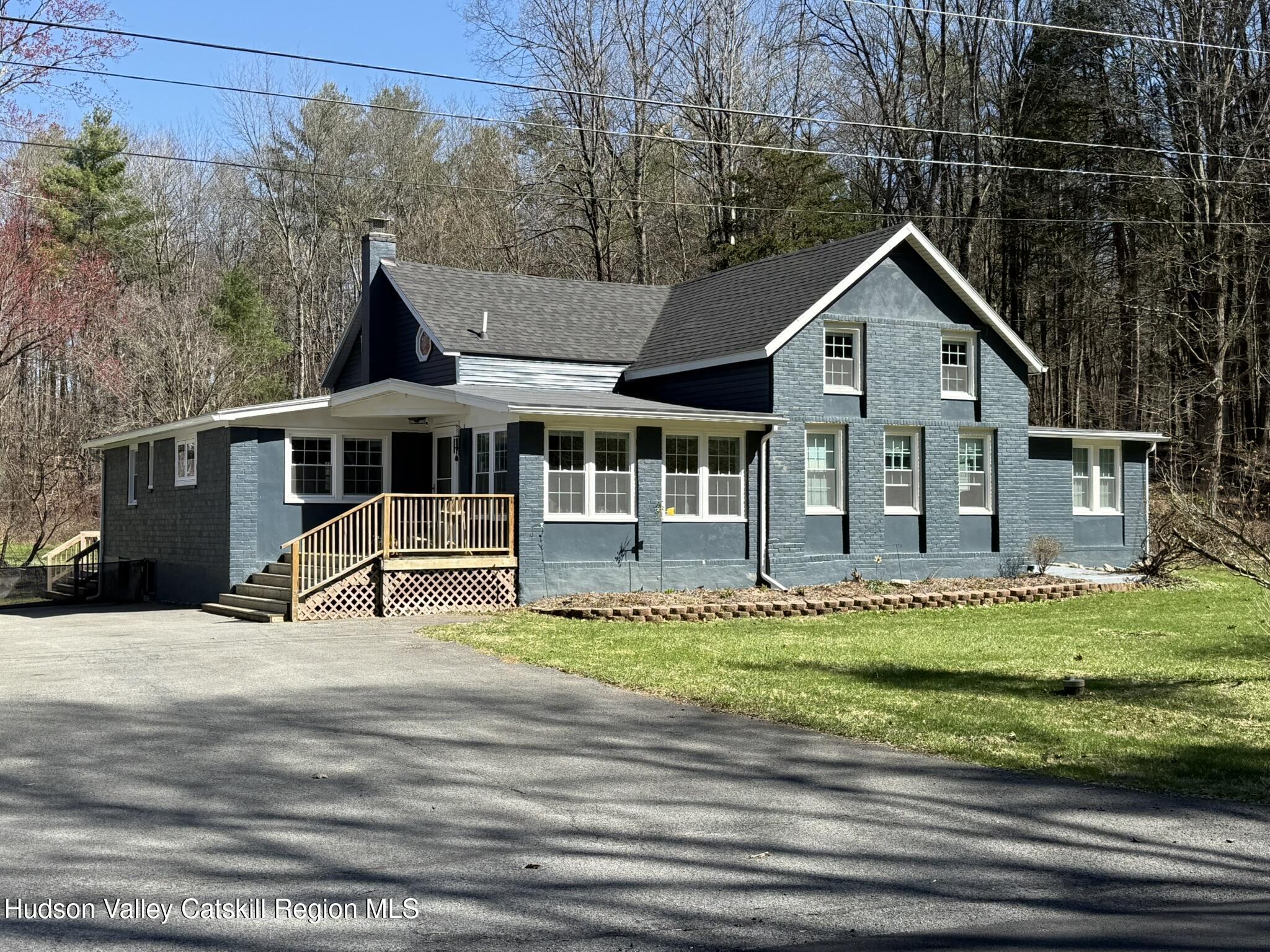 a front view of a house with a garden