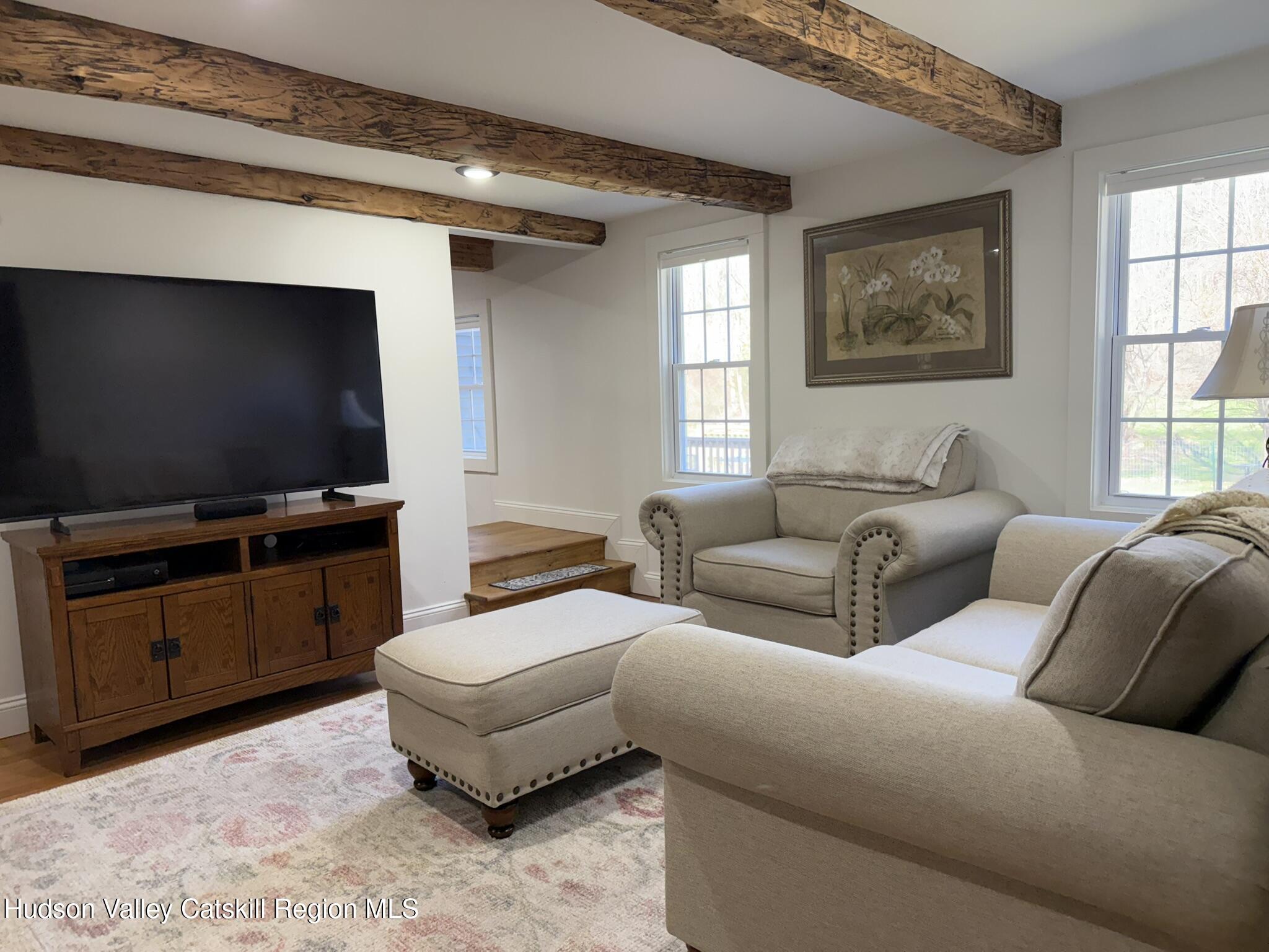 96 West Deans Mill Road New Baltimore, NY 12192 - Photo 17 of 60 a living room with furniture and a flat screen tv