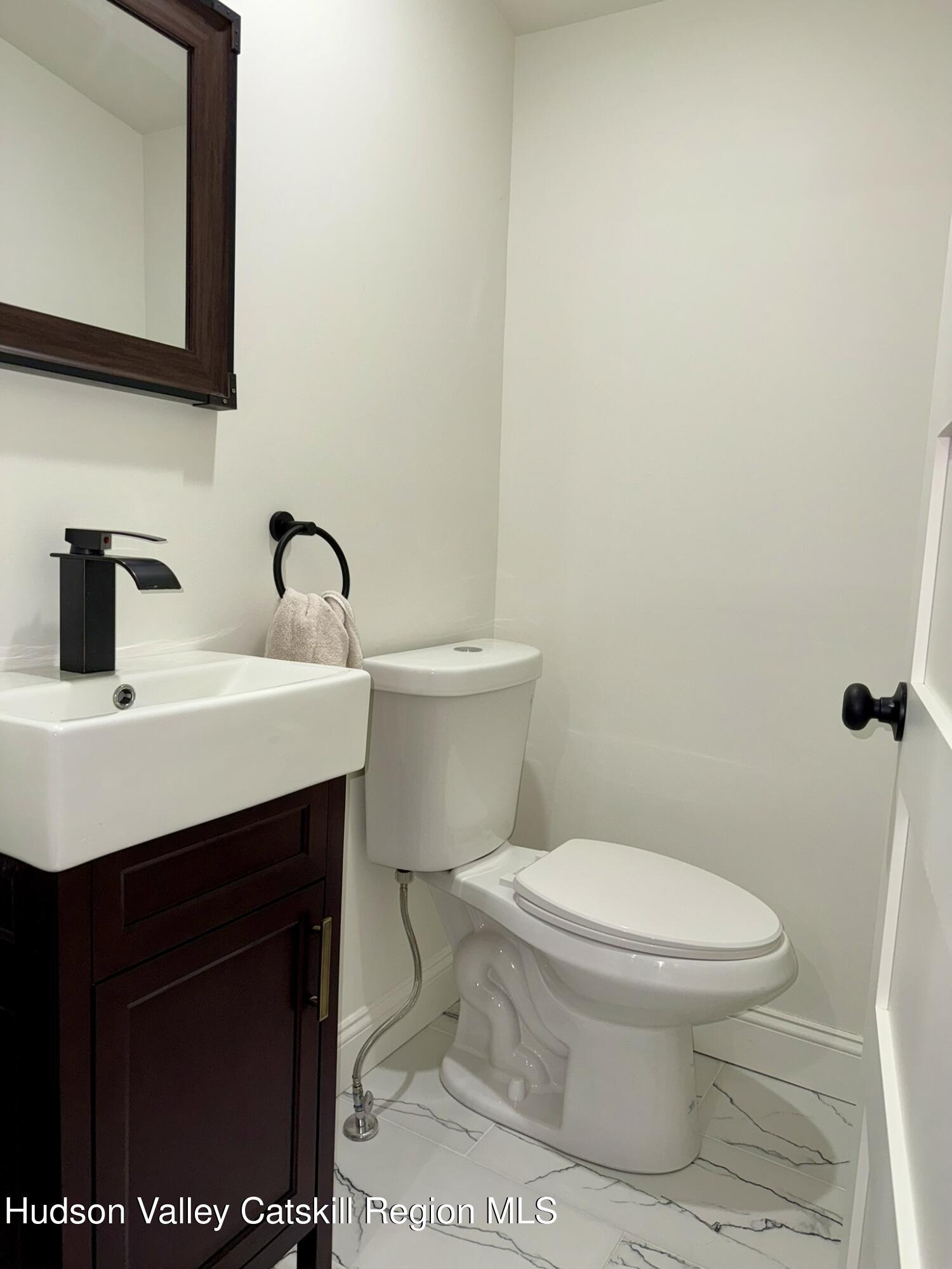 96 West Deans Mill Road New Baltimore, NY 12192 - Photo 19 of 60 a bathroom with a sink a toilet and mirror