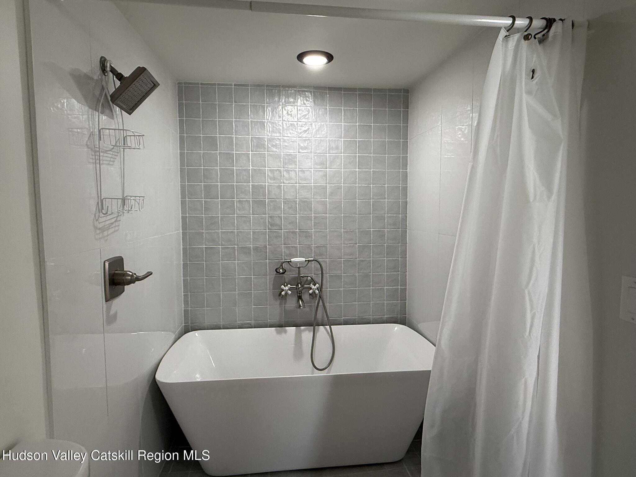 96 West Deans Mill Road New Baltimore, NY 12192 - Photo 22 of 60 a white bath tub sitting in a bathroom