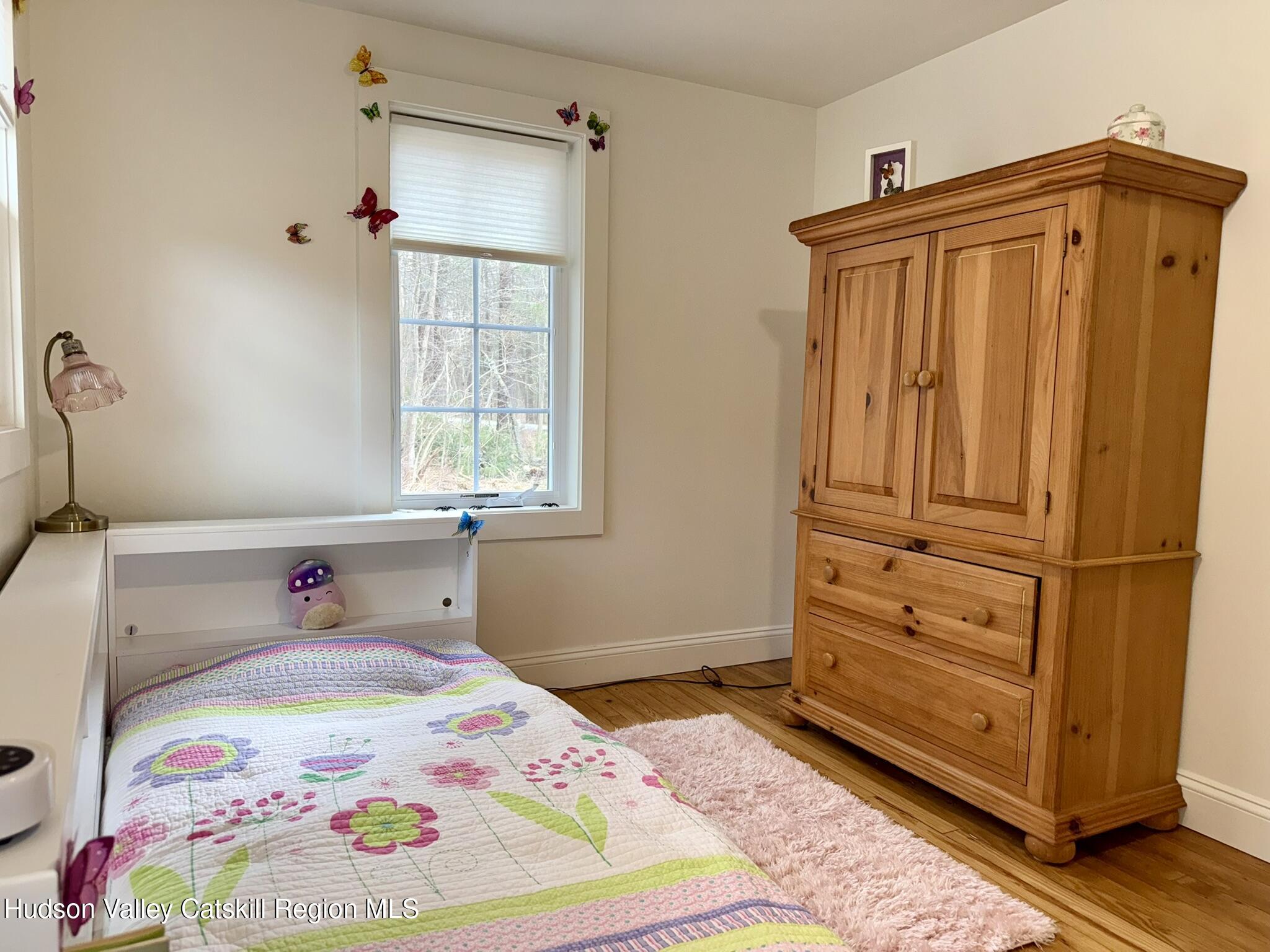96 West Deans Mill Road New Baltimore, NY 12192 - Photo 29 of 60 a bedroom with a bed and a window