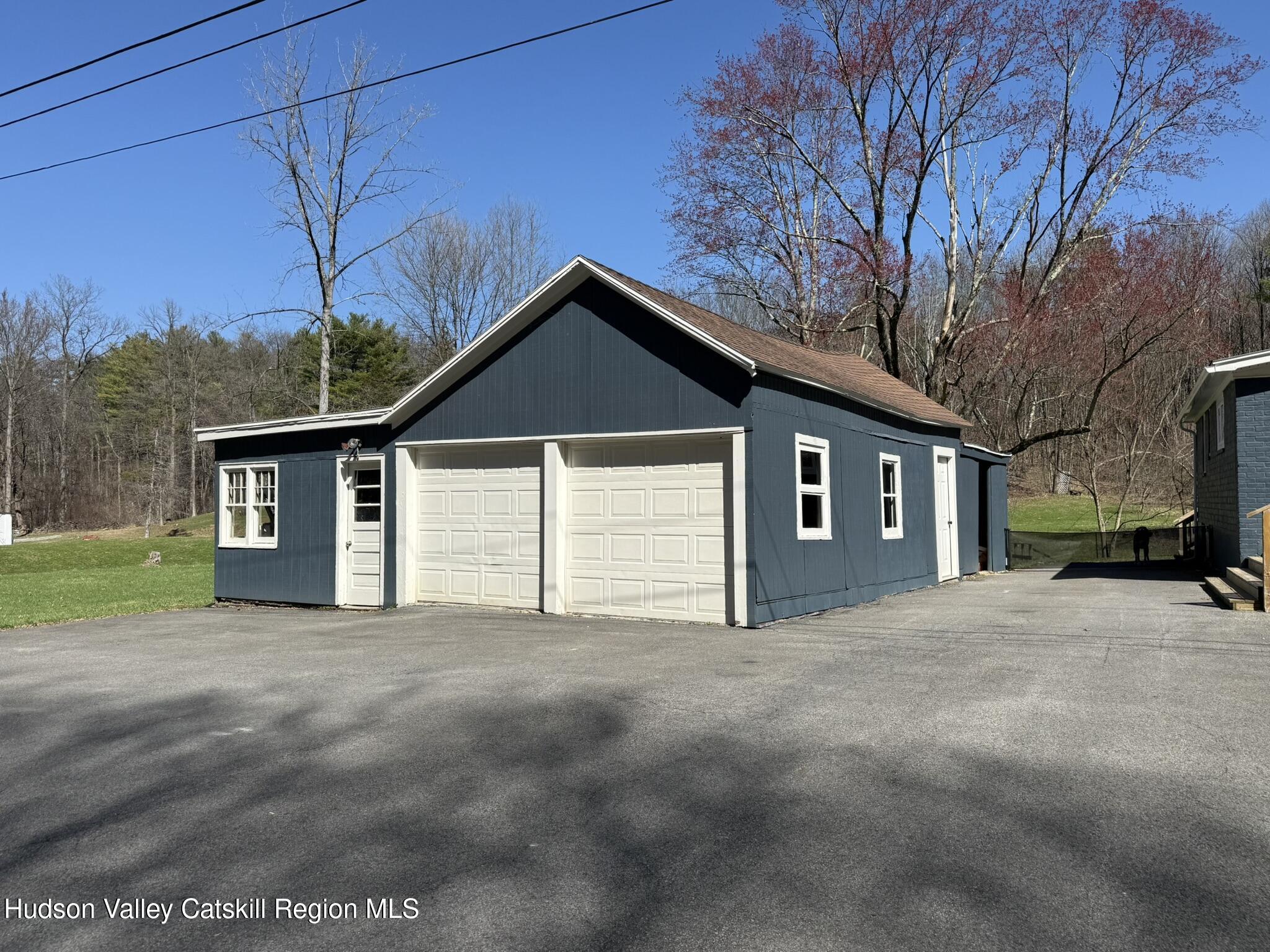 96 West Deans Mill Road New Baltimore, NY 12192 - Photo 48 of 60 a front view of a house with a yard and garage