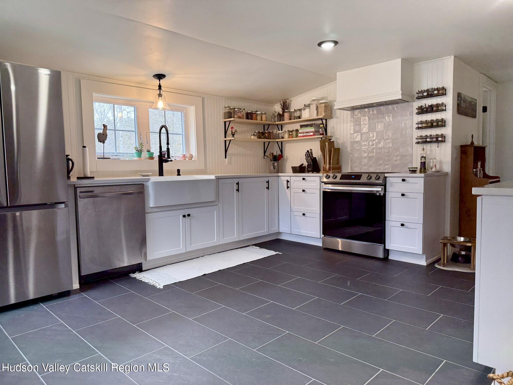 96 West Deans Mill Road New Baltimore, NY 12192 - Photo 7 of 60 a kitchen with stainless steel appliances granite countertop a refrigerator and a stove top oven