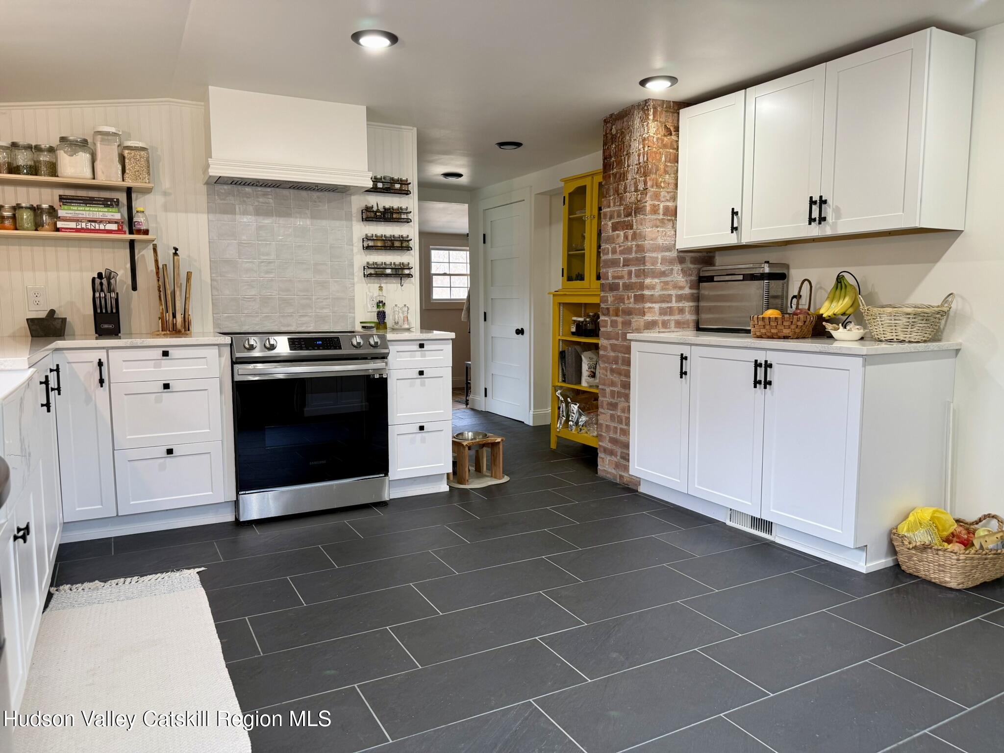 96 West Deans Mill Road New Baltimore, NY 12192 - Photo 8 of 60 a kitchen with stainless steel appliances a stove a sink and a refrigerator