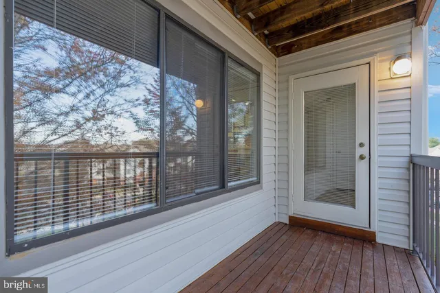 a view of front door and deck of the house