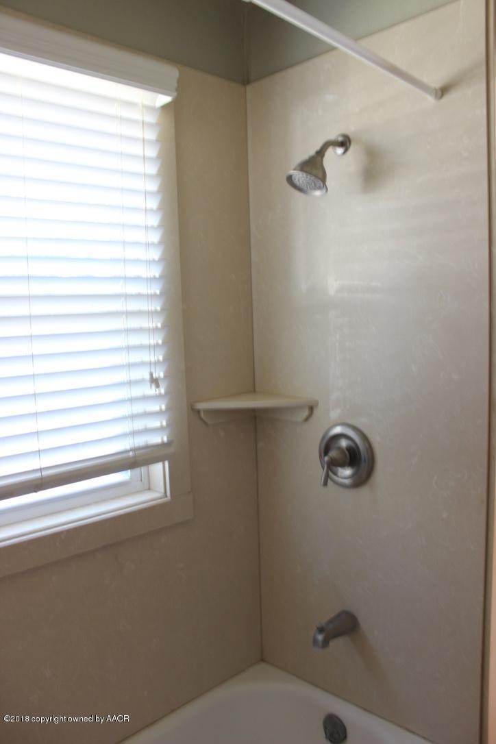 3405 South Taylor Street Amarillo, TX 79110 - Photo 11 of 26 a bathroom with a toilet and a window