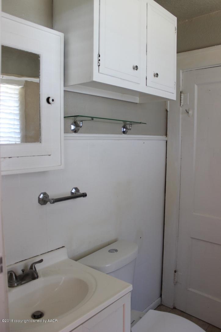 3405 South Taylor Street Amarillo, TX 79110 - Photo 12 of 26 a bathroom with a sink and cabinets