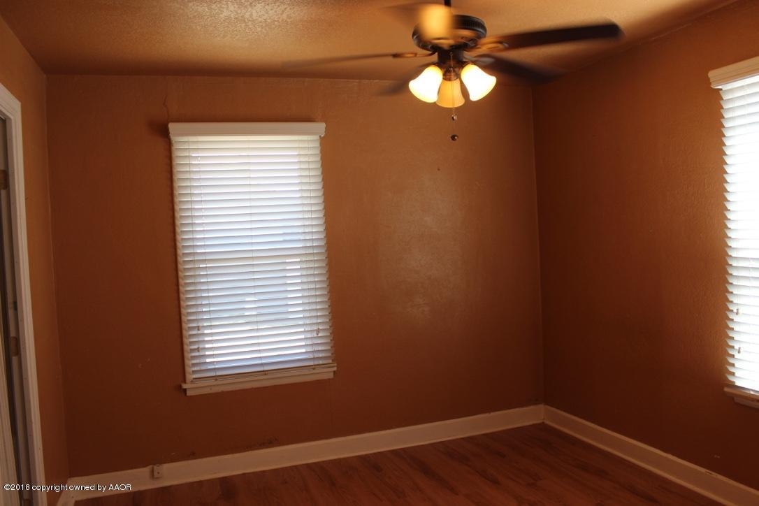 3405 South Taylor Street Amarillo, TX 79110 - Photo 9 of 26 a view of a room with wooden floor and windows