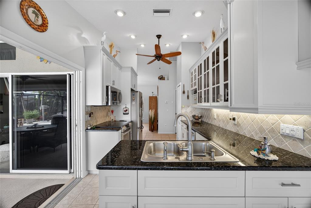 3612 Whippoorwill Boulevard Punta Gorda, FL 33950 - Photo 11 of 40 a kitchen with stainless steel appliances granite countertop a refrigerator and a sink
