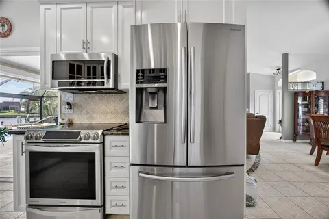 a kitchen with refrigerator a microwave and stove
