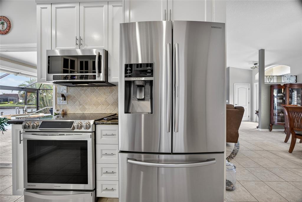 3612 Whippoorwill Boulevard Punta Gorda, FL 33950 - Photo 12 of 40 a kitchen with refrigerator a microwave and stove