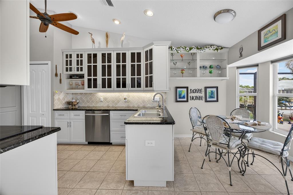 3612 Whippoorwill Boulevard Punta Gorda, FL 33950 - Photo 13 of 40 a kitchen with stainless steel appliances granite countertop a stove and a refrigerator